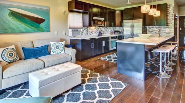 Modern condominium kitchen and living area with stylish decor and hardwood flooring, restored after water damage